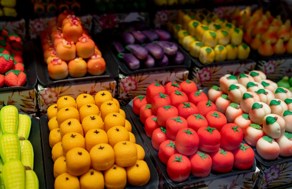 A vibrant display of marzipan shaped as fruits and vegetables in Istanbul. Captures colorful food art.